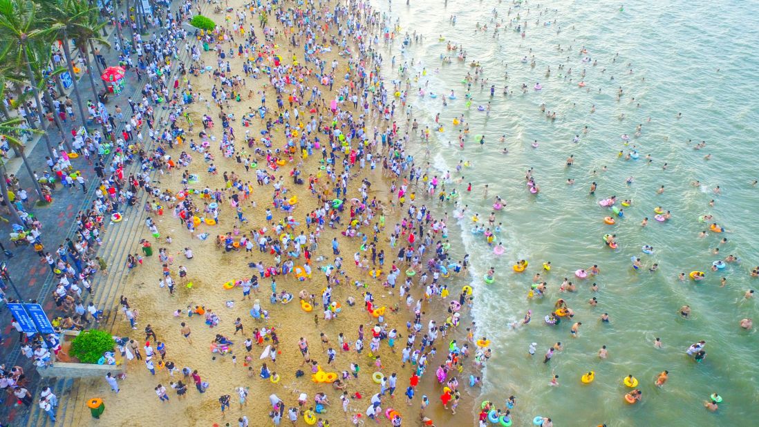 <strong>Dragon Water: </strong>Aerial view of people bathing in "dragon water," a local custom to mark the Dragon Boat Festival or Duanwu Festival, at a beach resort in Hainan's Haikou city. More than 200,000 local people and tourists took a dip at this year's festival. 