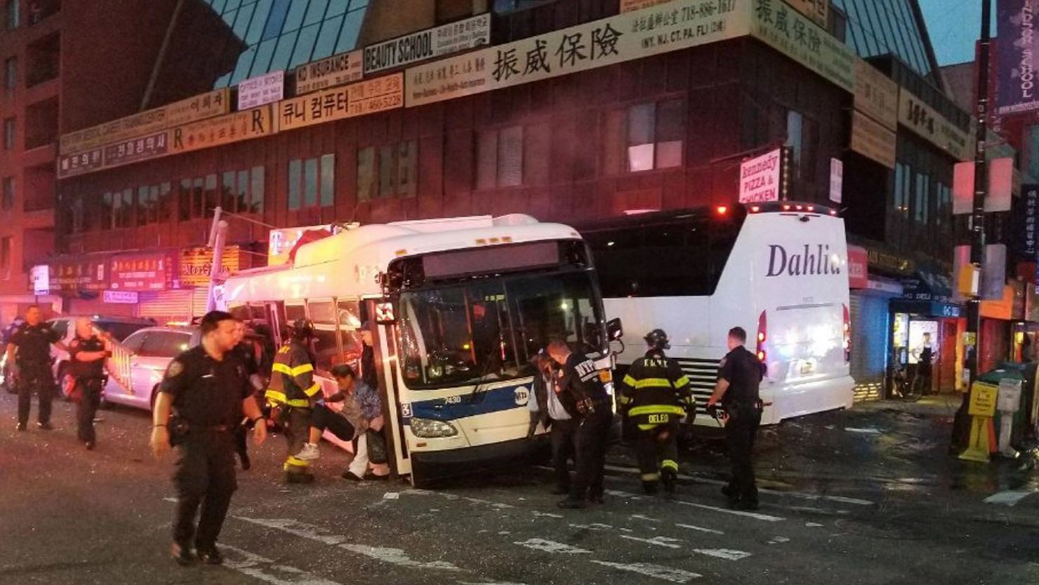 NYPD officers respond to a collision involving two buses in the Queens borough of New York.