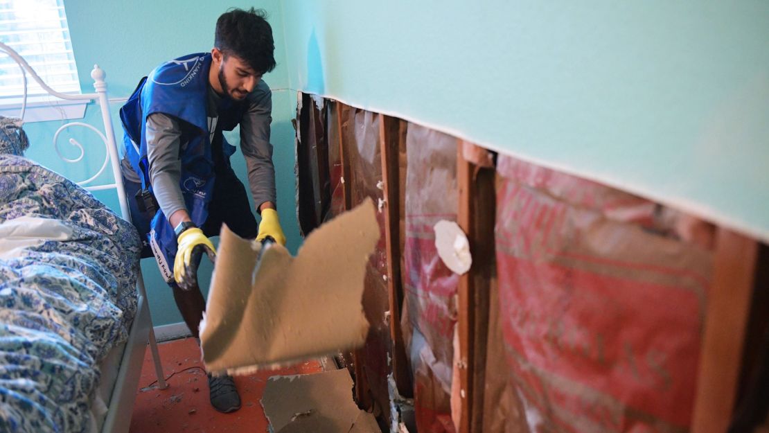 An Ahmadiyya Muslim Youth Association member removes flood-damaged drywall from a home in Houston's Westbury neighborhood.