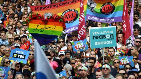 Supporters hold placards as they attend a same-sex marriage rally in Sydney on September 10, 2017.