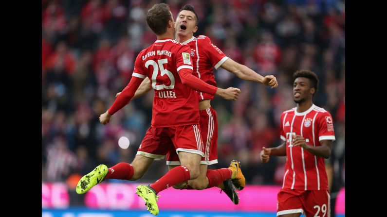 Bayern Munich teammates Thomas Muller, left, and Robert Lewandowski celebrate Muller's opening goal during a German league match against Mainz on Saturday, September 16. Bayern rolled to a 4-0 victory.