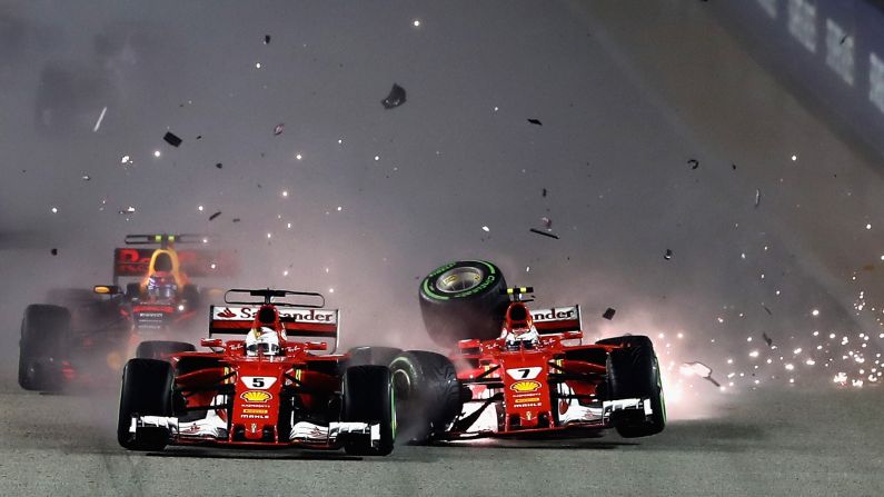 Ferrari teammates Sebastian Vettel, left, and Kimi Raikkonen collide at the start of <a href="index.php?page=&url=http%3A%2F%2Fwww.cnn.com%2F2017%2F09%2F17%2Fmotorsport%2Fsingapore-gp-f1-rain-vettel-hamilton-verstappen-ricciardo-ferrari%2Findex.html" target="_blank">the Formula One race in Singapore</a> on Sunday, September 17. Lewis Hamilton won the rain-soaked race.