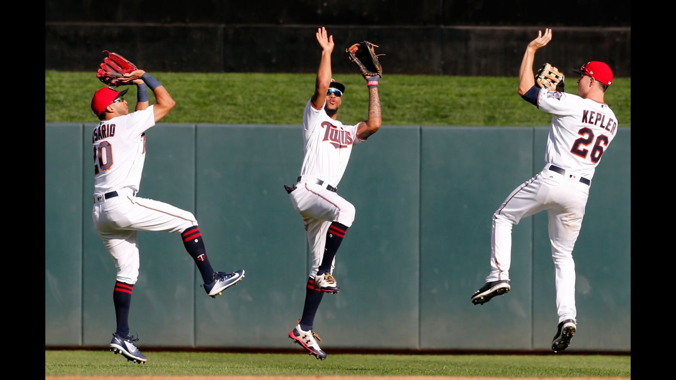 Minnesota outfielders Eddie Rosario, Byron Buxton and Max Kepler mimic basketball players as they celebrate a 13-7 victory over Toronto on Sunday, September 17.