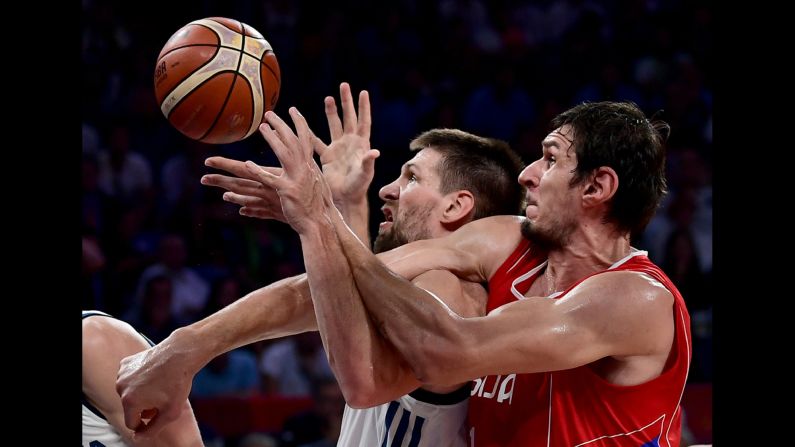 Slovenian center Gasper Vidmar, center, tussles with Serbian center Boban Marjanovic during <a href="index.php?page=&url=http%3A%2F%2Fbleacherreport.com%2Farticles%2F2733702-eurobasket-2017-final-goran-dragics-35-points-power-slovenia-past-serbia" target="_blank" target="_blank">the EuroBasket final</a> on Sunday, September 17. Slovenia won 93-85 behind 35 points from Goran Dragic. Dragic was named the tournament's MVP.