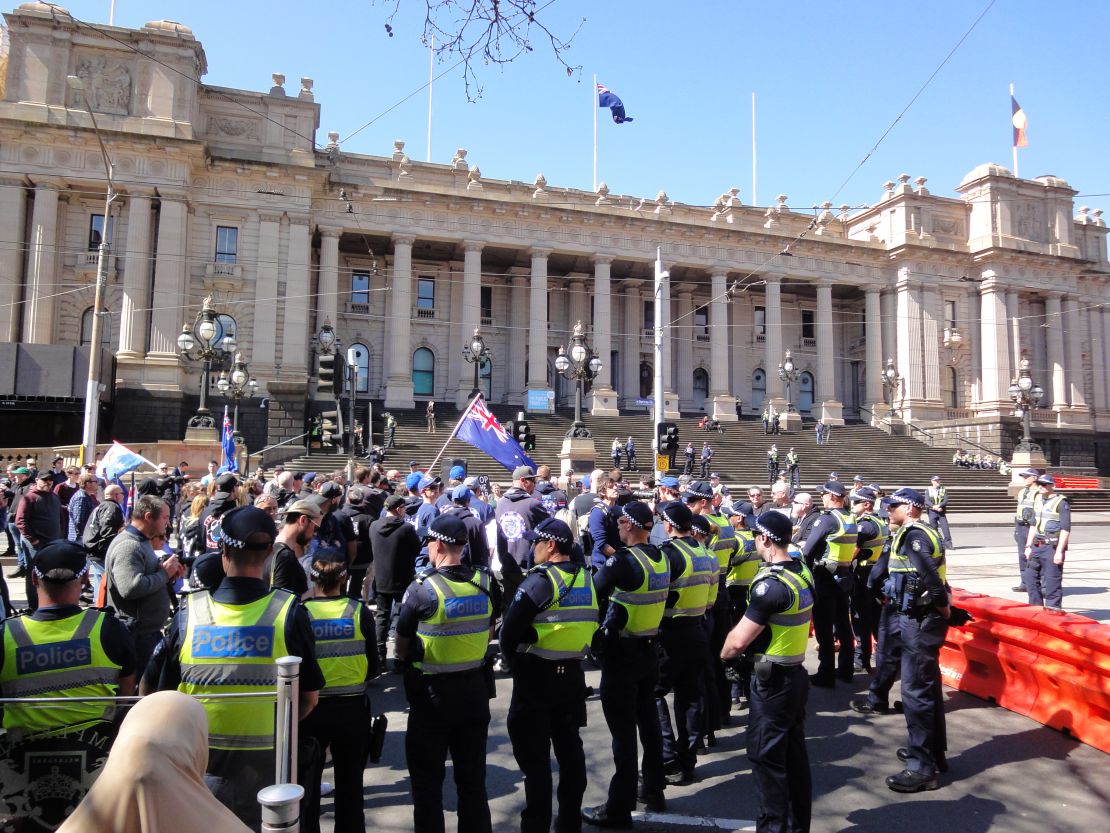 Victoria police officers keep apart rival protests in Melbourne on Sunday, September 17.