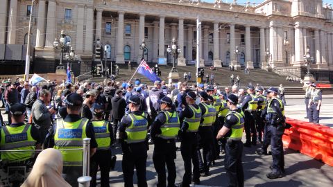 Victoria police officers keep apart rival protests in Melbourne on Sunday, September 17.