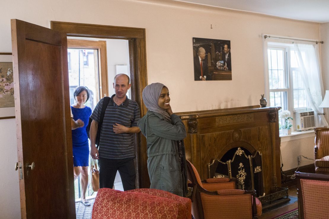 From left to right: Uyen Nguyen, Ghassan Shehadeh and Eiman Ali, who all came to the US as refugees, walk into the living room of Trump's childhood home.