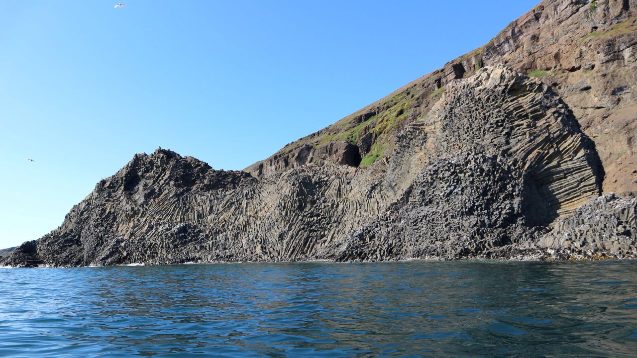 To land here, you have to find a relatively safe bit of rock to try and dock the boat and jump ashore, before scaling the basalt cliffs.