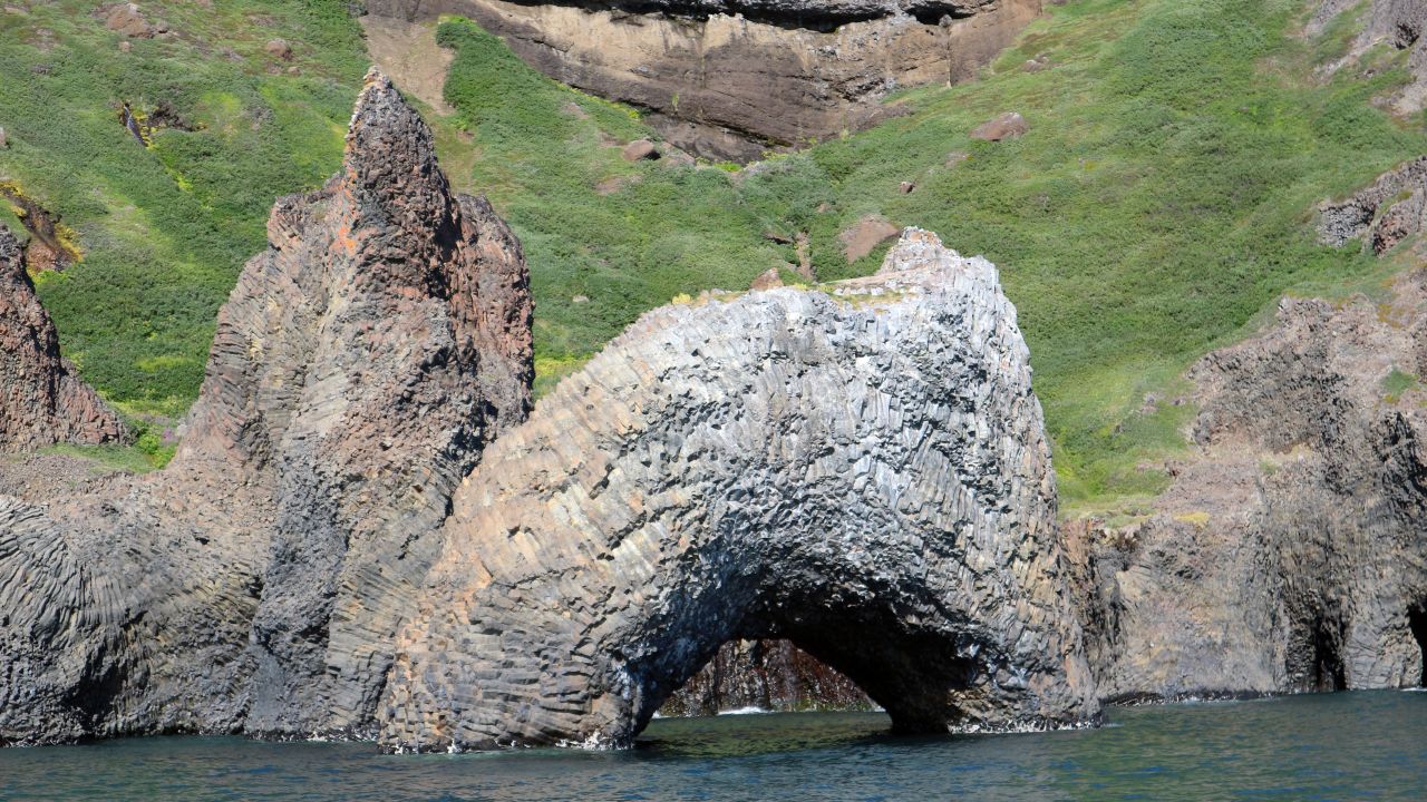 Further down the coast, huge stone arches appear, big enough to sail through. 