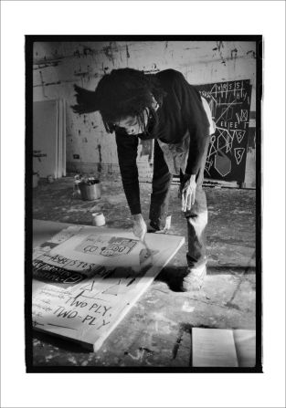 Jean-Michel Basquiat at work in 1983.
