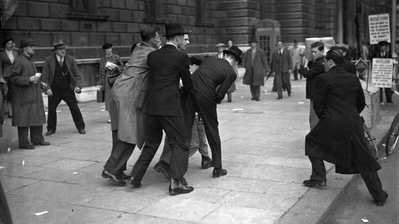 <strong>Fascism in London:</strong> Rosenberg's tours also cover the 1936 when a march by the British Union of Fascists was disrupted by anti-fascist demonstrators. In this picture from 1938, fascists and Jews clash at Whitehall during the Munich negotiations between Neville Chamberlain and Adolf Hitler. 