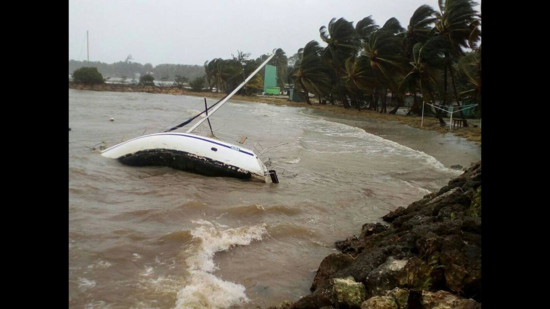 A boat is overturned off the shore of Sainte-Anne, Guadeloupe, on September 19.