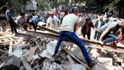 People remove debris of a building which collapsed after an earthquake rattled Mexico City on September 19.
A powerful earthquake shook Mexico City on Tuesday, causing panic among the megalopolis' 20 million inhabitants on the 32nd anniversary of a devastating 1985 quake.