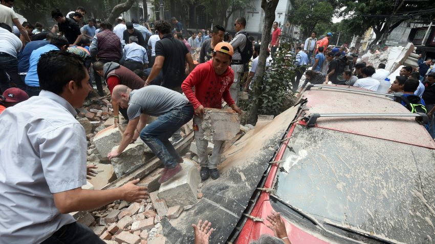People remove debris of a building which collapsed after an earthquake rattled Mexico City on September 19.