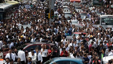 People gather on a Mexico City street after office buildings were evacuated because of the quake.