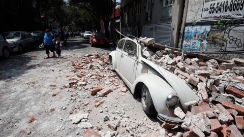A car is crushed by debris in Mexico City on September 19.