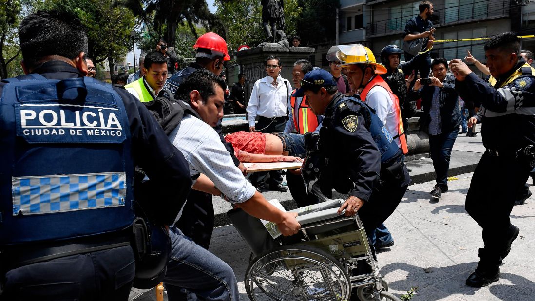 A woman receives medical assistance after she was injured in Mexico City on September 19.