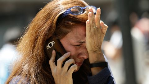 A woman in Mexico City cries as she tries to reach people on her cell phone after the quake.
