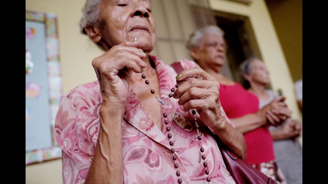 People pray in Humacao on September 19.