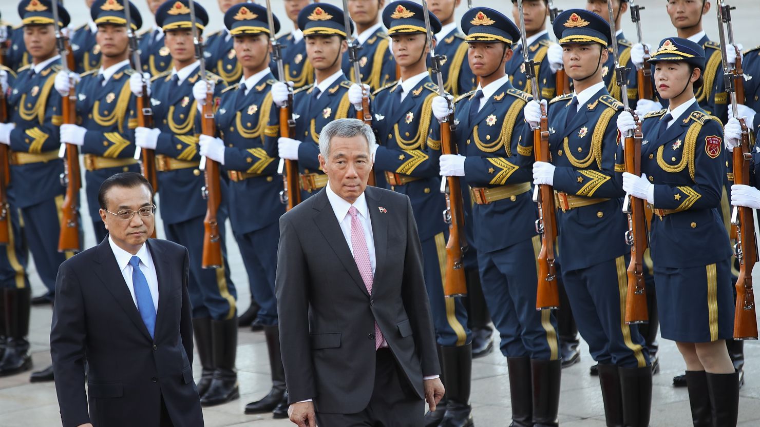 Singapore Prime Minister Lee Hsien Loong views a guard of honor with China's Premier Li Keqiang during a welcoming ceremony outside the Great Hall of the People on September 19, 2017 in Beijing, China.