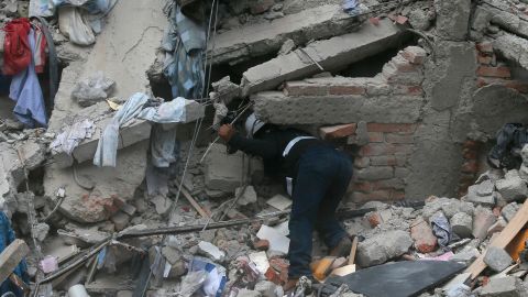 A construction worker searches a building that collapsed after an earthquake in the Roma neighborhood of Mexico City on September 19.