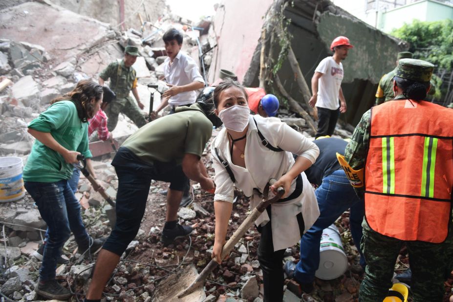 Emergency workers remove debris as they search for survivors in Mexico City on September 19.