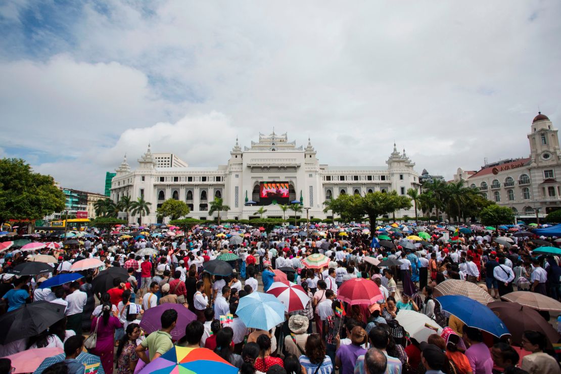 People gather to listen to the live speech of Myanmar's State Counselor Aung San Suu Kyi in front of City Hall in Yangon on September 19, 2017.  