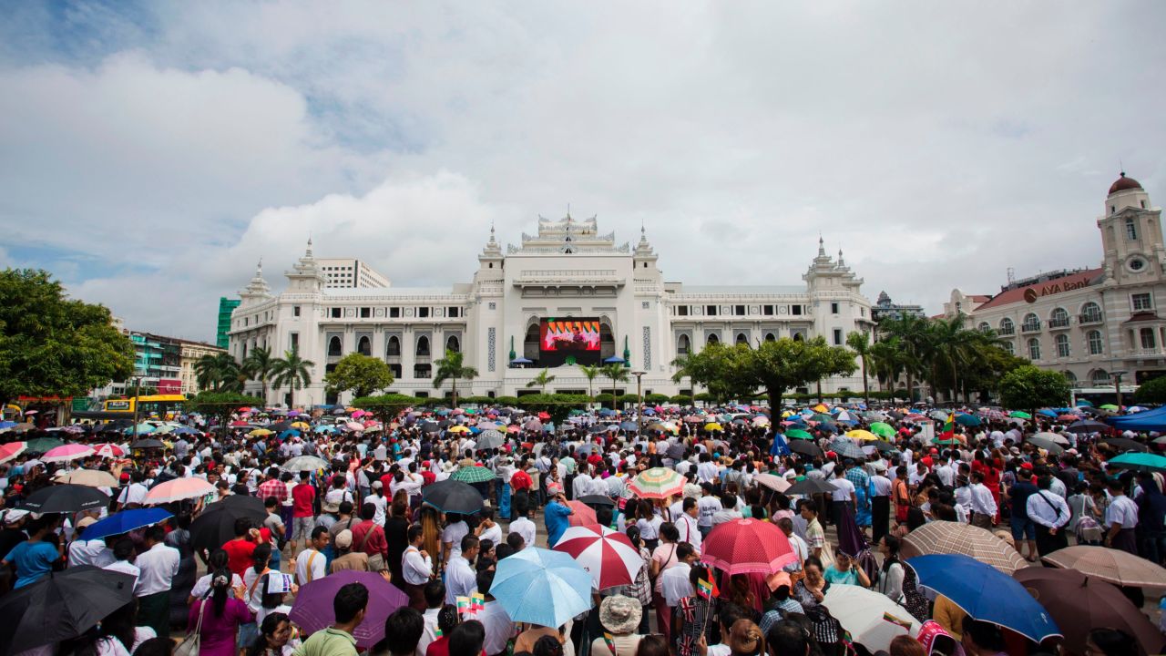 People gather to listen to the live speech of Myanmar's State Counselor Aung San Suu Kyi in front of City Hall in Yangon on September 19, 2017.  