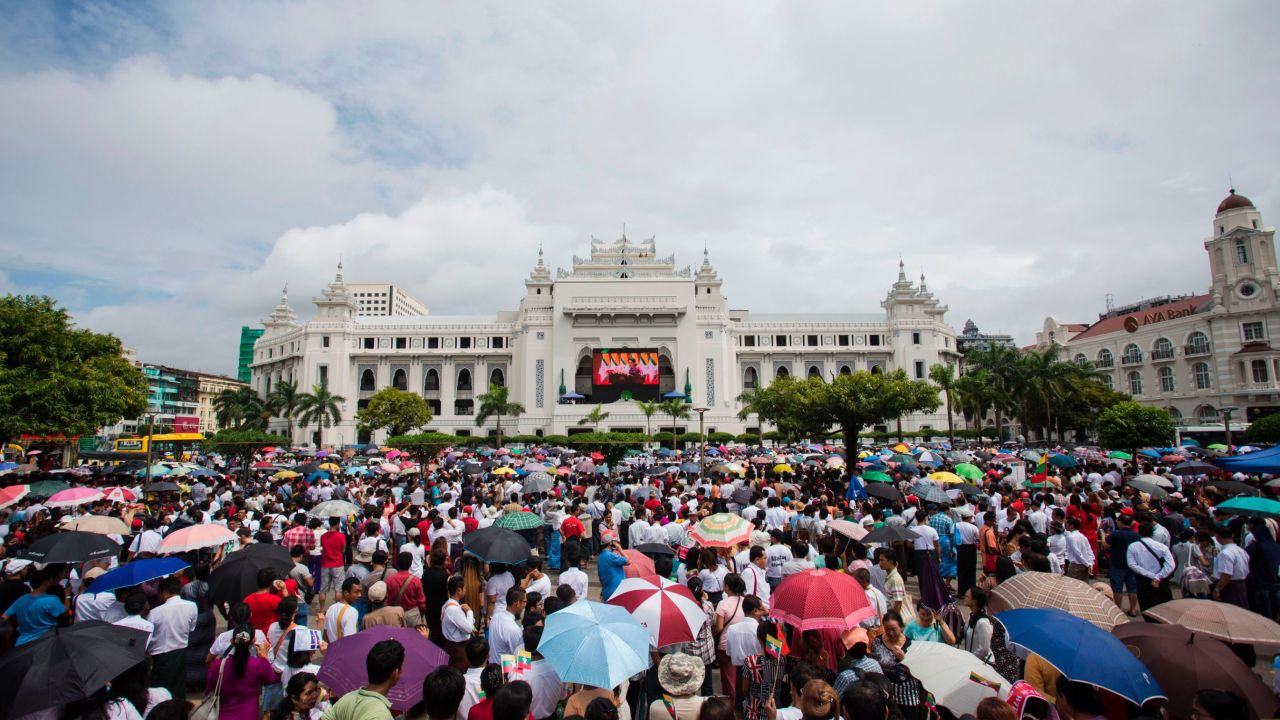 People gather to listen to the live speech of Myanmar's State Counselor Aung San Suu Kyi in front of City Hall in Yangon on September 19, 2017.