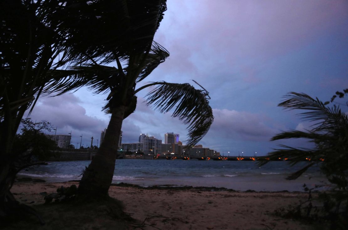 Palm trees blow in the wind late Tuesday in San Juan, Puerto Rico, where the governor warned that the island faced an "imminent danger" from Hurricane Maria.