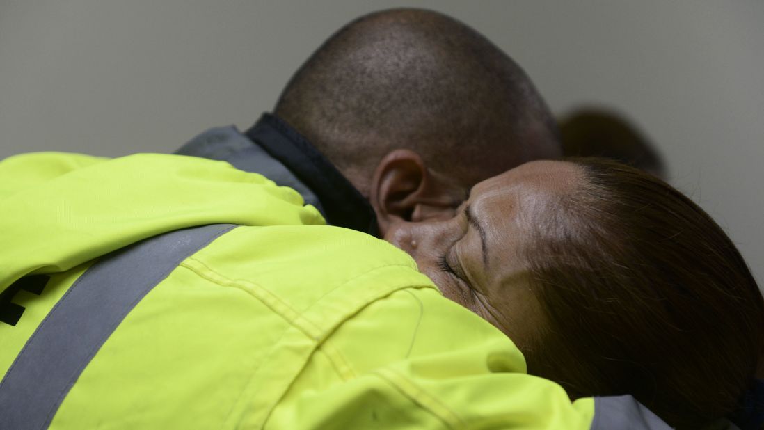 Members of a rescue team embrace as they wait to help in Humacao on September 20.