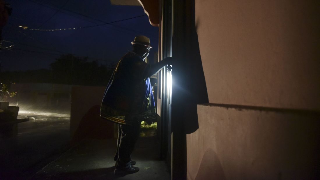 A woman closes her property in Naguabo, Puerto Rico, hours before Maria's arrival.