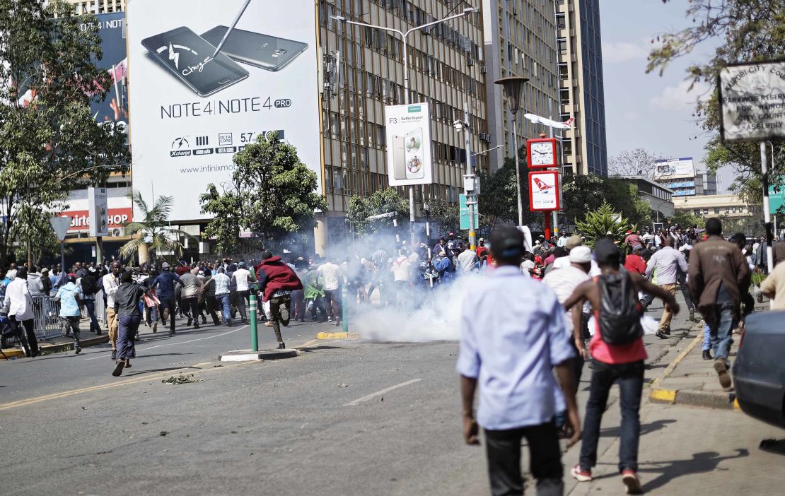 Police fire tear gas at supporters of President Uhuru Kenyatta after they tried to push past a barrier into the court parking lot in Nairobi, Kenya on Tuesday, September 19.