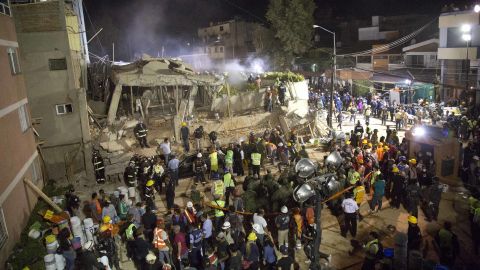 Volunteers and rescue workers search for survivors inside the school.