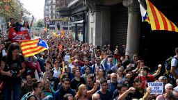 People holding  'Esteladas' (Catalan pro-independence flags) attend a protest in front of the Economy headquarters of Catalonia's regional government in Barcelona on September 20, 2017, during a search by Spain's Guardia Civil police.Spain's Guardia Civil police arrested a top Catalan government official on as part of raids on several Catalan government offices, sparking protests in Barcelona. The operation comes amid mounting tensions as Catalan leaders press ahead with preparations for an independence referendum on October 1 despite Madrid's ban and a court ruling deeming it illegal. / AFP PHOTO / LLUIS GENE        (Photo credit should read LLUIS GENE/AFP/Getty Images)