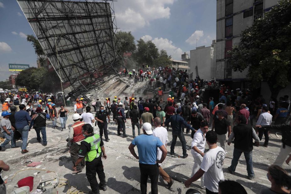 Rescue workers and volunteers search a collapsed building in Mexico City on September 19.