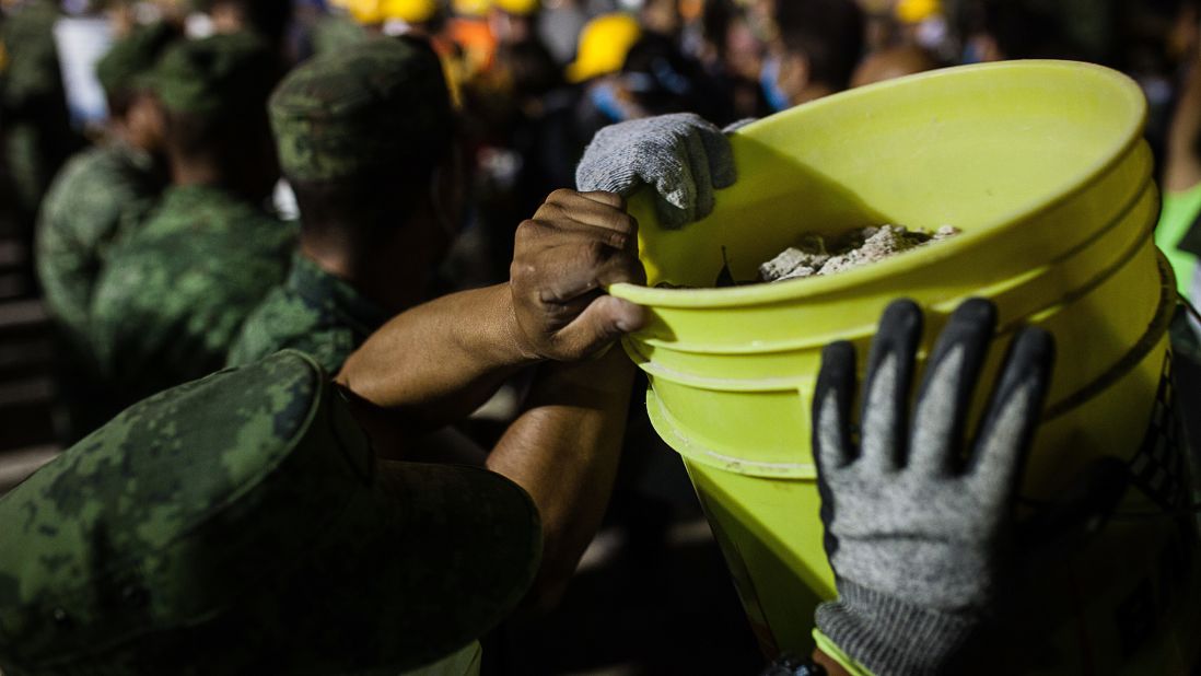 Soldiers remove debris from a collapsed building in Mexico City on September 20.