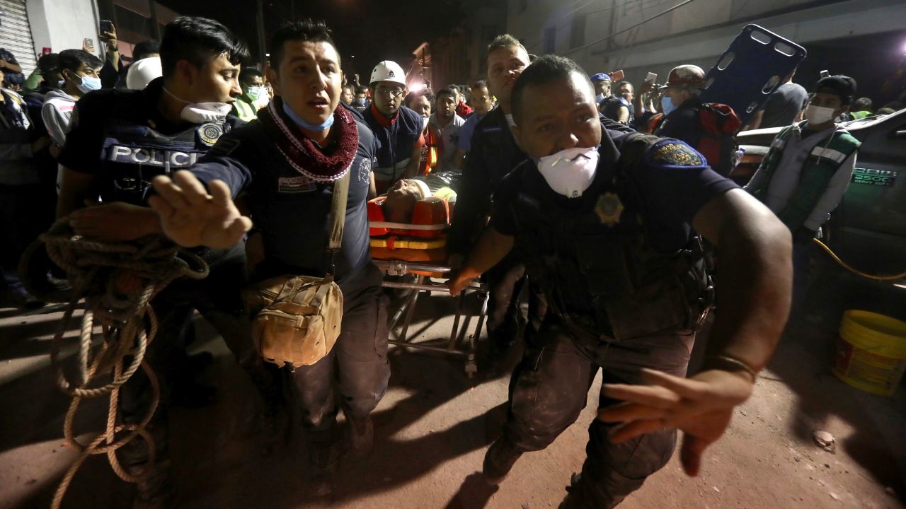 An injured person is carried away after being rescued in Mexico City on Tuesday, September 19. The earthquake happened on the anniversary of a 1985 quake that killed an estimated 9,500 people in and around Mexico City.