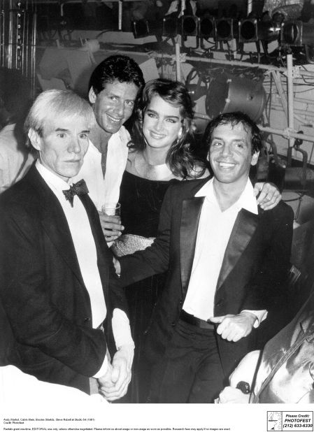 Andry Warhol, Calvin Klein and Brooke Shields pose with Studio 54 co-founder Steve Rubell (right). 