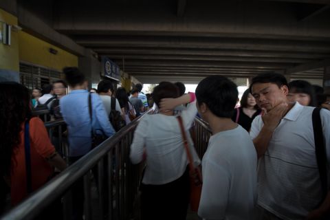 Commuters wait to enter a subway station during the morning rush hour in Beijing. Despite some five million private vehicles in Beijing, public transport faces heavy congestion on a daily basis as most of the city's 21.5 million people head to work. 