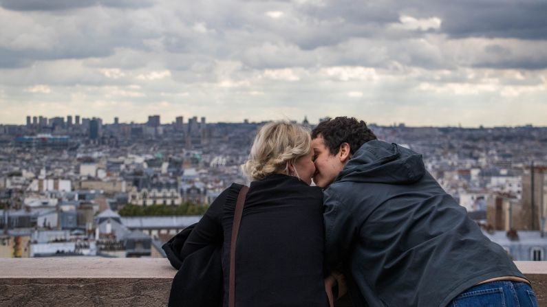 <strong>Paris: </strong>Tourists kiss as they take in the view from outside the Sacré-Coeur Basilica in Montmartre. 