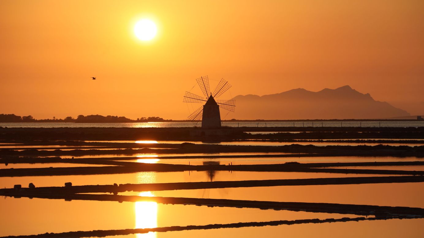 <strong>Marsala, Italy: </strong>The sun sets over a windmill in the Sicilian coastal town of Marsala, famous for its wine. <br />