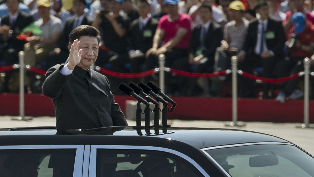 BEIJING, CHINA - SEPTEMBER 03:  Chinese president and leader of the Communist Party Xi Jinping rides in an open top car as he greets soldiers and others in front of Tiananmen Square and the Forbidden City during a military parade on September 3, 2015 in Beijing, China. China is marking the 70th anniversary of the end of World War II and its role in defeating Japan with a new national holiday and a military parade in Beijing.  (Photo by Kevin Frayer/Getty Images)