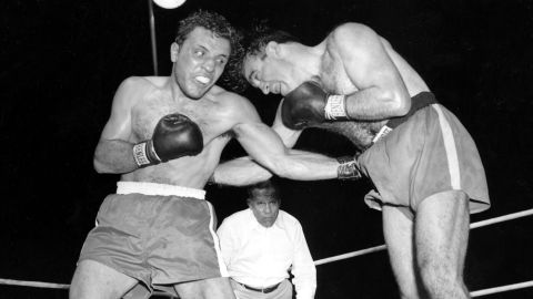 Jake LaMotta, left, pounds Marcel Cerdan in the third round of their 1949 world middleweight title bout in Detroit, Mich. LaMotta won the title by a knockout in the tenth round. 