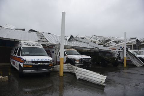 Rescue vehicles are trapped under an awning in Humacao on September 20.
