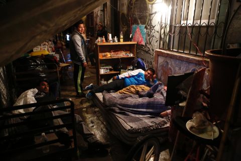 Families prepare to sleep under tarps outside their quake-damaged building in Mexico City on September 20. 