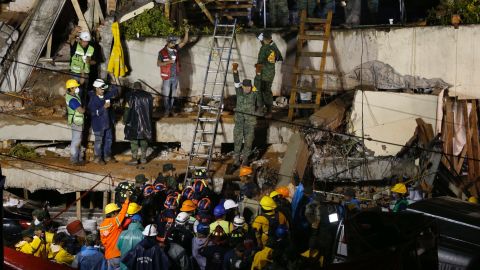 Rescue crews rush to save survivors trapped under the collapsed school.