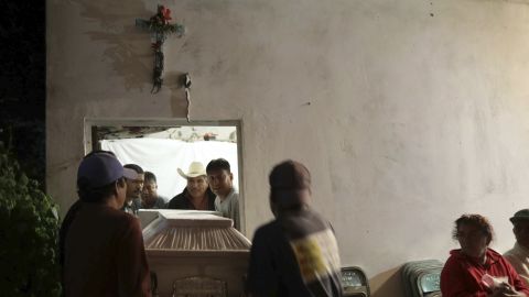 Residents carry the casket of one of the victims.