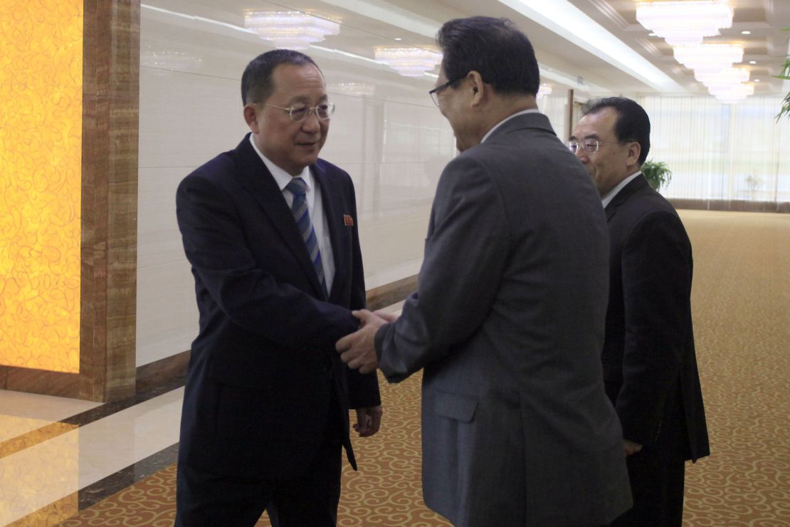 North Korean Foreign Minister Ri Yong Ho, left, shakes hands with North Korean Vice Foreign Minister Pak Myong Guk as he leaves the Pyongyang Airport on Tuesday. 