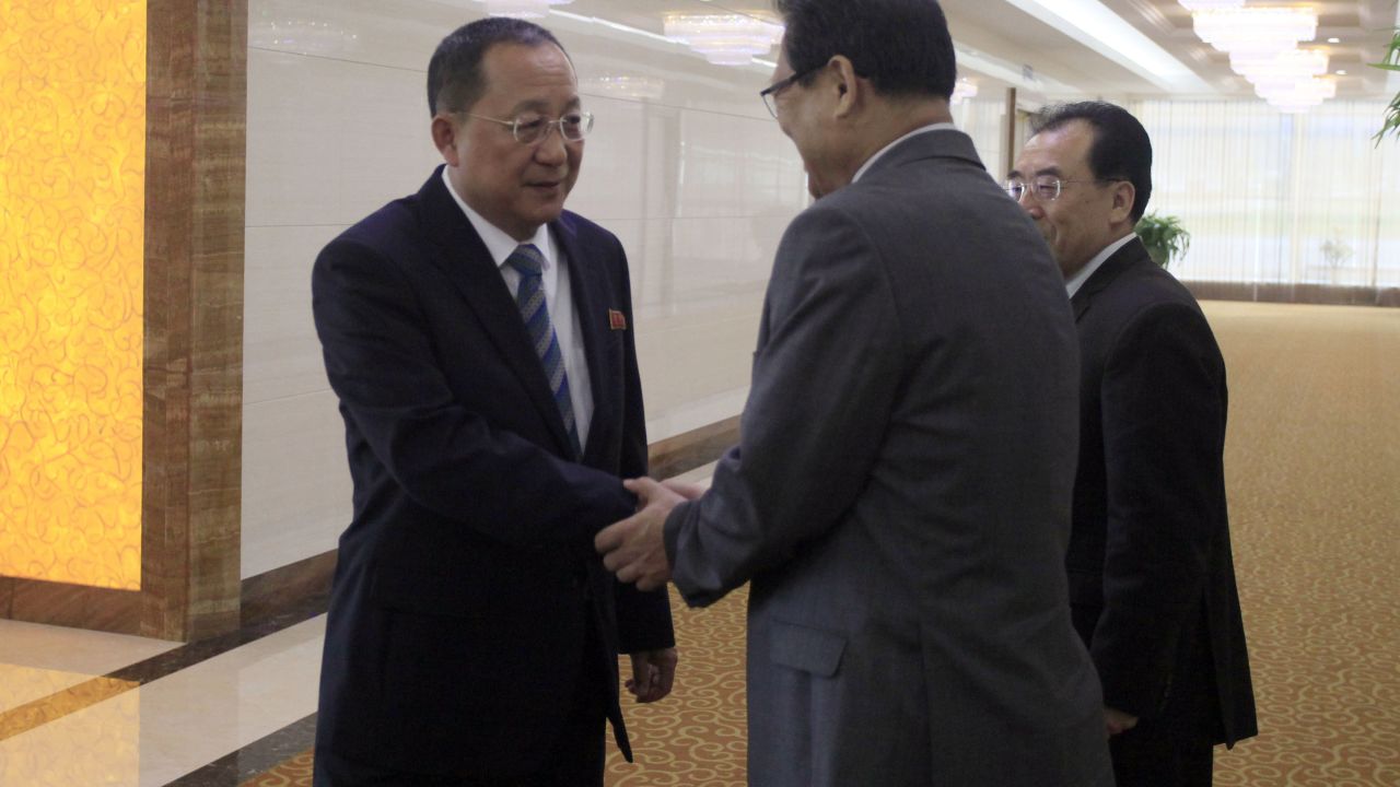 North Korean Foreign Minister Ri Yong Ho, left, shakes hands with North Korean Vice Foreign Minister Pak Myong Guk as he leaves the Pyongyang Airport on Tuesday.